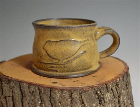 A Coffee Cup Sitting On Top Of A Tree Stump