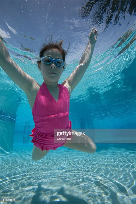 Girl Floating Toward Camera Underwater In Pool High Res Stock Photo