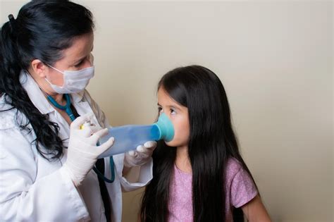 Premium Photo Closeup Shot Of Pediatrician In Facial Mask Examining A