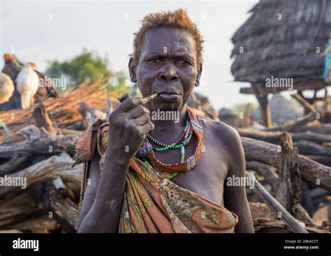 Senior Toposa Tribe Woman Smoking Pipe In A Village Namorunyang State