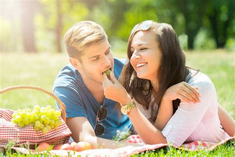 Smiling Woman Feeding Grape To Her Boyfriend Stock Photo Image Of