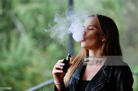Closeup Of Woman Smoking Electronic Cigarette High Res Stock Photo
