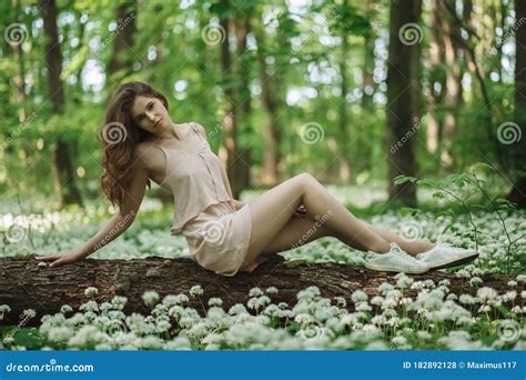 Beautiful Sensual Woman In Forest Meadow With Flower Stock Photo