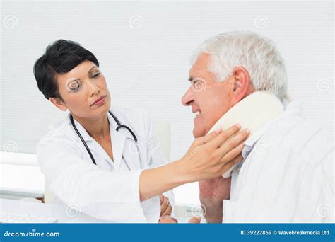 Female Doctor Examining A Senior Patients Neck Stock Image Image Of