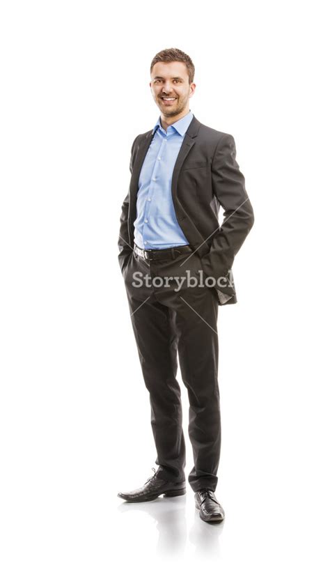 Successful Business Man In Suit Is Posing In Studio Isolated Over White