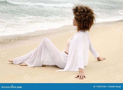 Beautiful Girl With Afro Hair And White Dress Relax On The Beach Stock