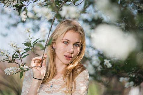 Young Beautiful Blonde Woman In Blooming Garden Delicate Girl Enjoys