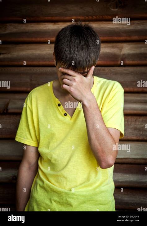 Sad Young Man By The Wooden Wall Stock Photo Alamy