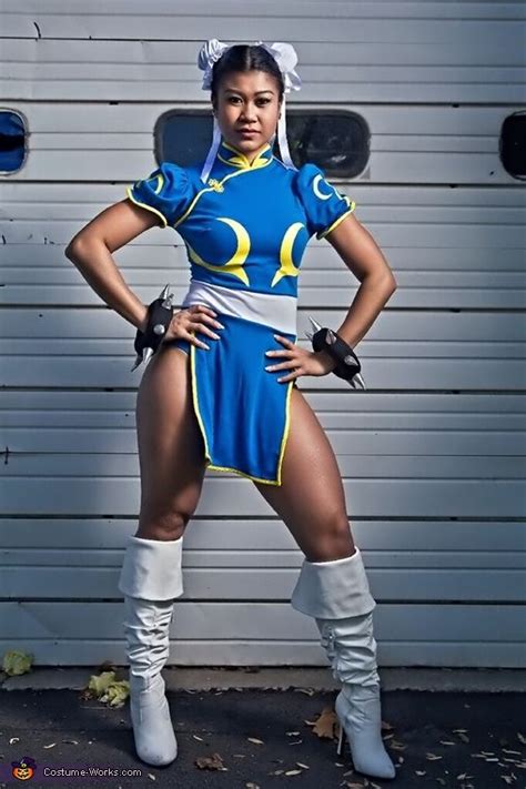 A Woman In A Blue And Yellow Costume Posing For The Camera With Her Hands On Her Hips