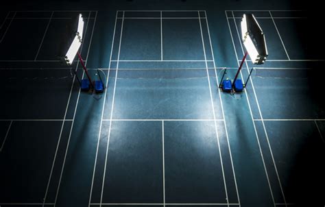 Badminton center court offers a complete line of badminton products and services to give you the best badminton experience. Indoor badminton court with bright white lights Photo ...