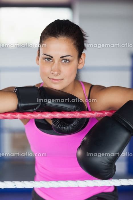 Portrait Of A Beautiful Young Woman In Black Boxing Gloves In The Ringの