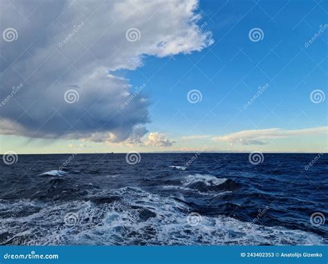 Dense Gray Cumulus Clouds Over The Water Surface Of The Sea Stock Image
