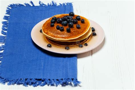 Pancakes With Honey And Blueberries On A Blue Napkin Stock Image