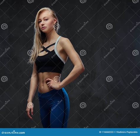 Slim Blonde Girl In A Sportswear Posing In A Studio Stock Image