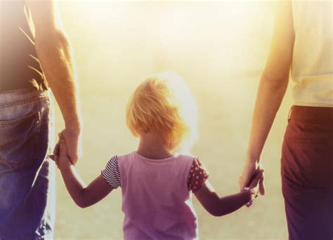 Into The Light Parents Hold Hands With Their Child Free Stock Photo