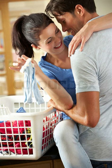 Romantic Couple Sorting Laundry In Kitchen Stock Image Colourbox