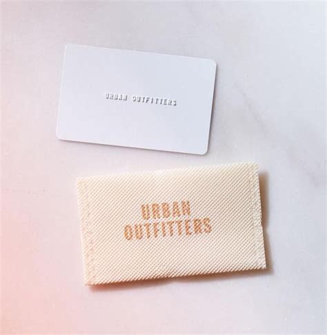 A White Business Card Sitting On Top Of A Table Next To A Small Piece