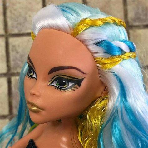 A Close Up Of A Doll With Blue Hair And Yellow Braids On Its Head