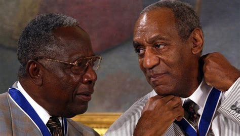 comedian bill cosby adjusts his presidential medal of freedom as baseball great hank aaron left