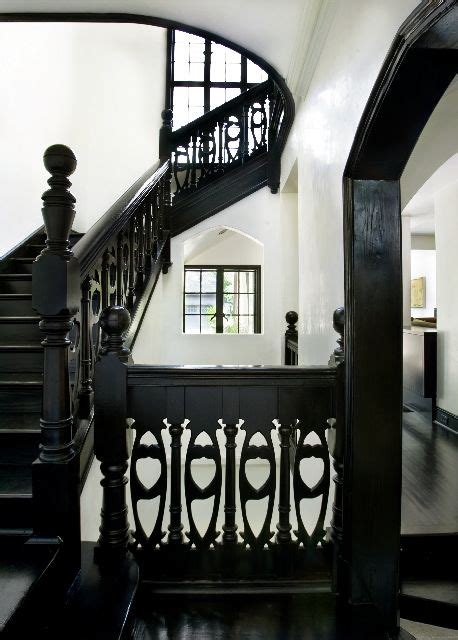 A Staircase In An Old House With Black And White Photograph