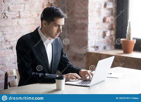 Concentrated Businessman Looking At Laptop And Typing Stock Image