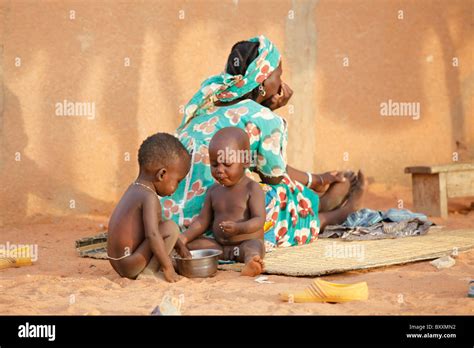 Two Young Fulani Children Eat With Their Hands In Djibo In Northern