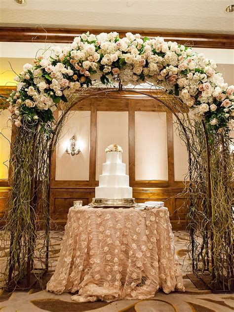 Repurpose The Wedding Arch After The Ceremony To Create A Stunning Cake Display Indoor Wedding