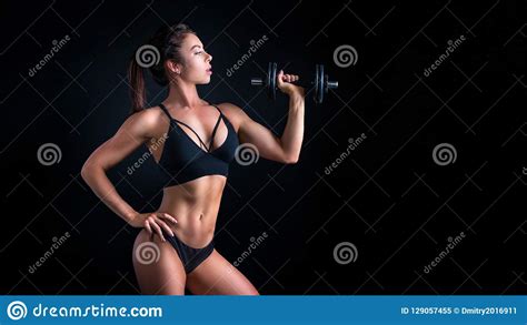Brutal Athletic Woman Pumping Up Muscles With Dumbbells Stock Image