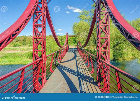 Iron Red Suspension Pedestrian Bridge Over The Little River Stock Photo