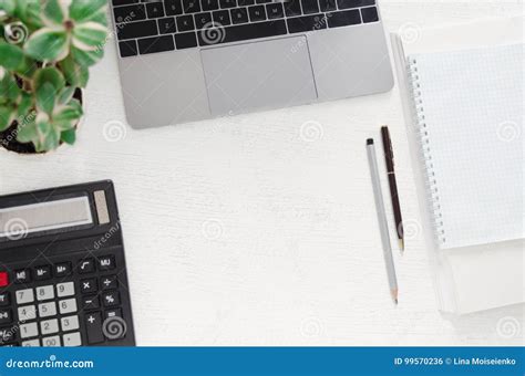 Workplace In Office Desk With Laptop Calculator Stack Of Papers