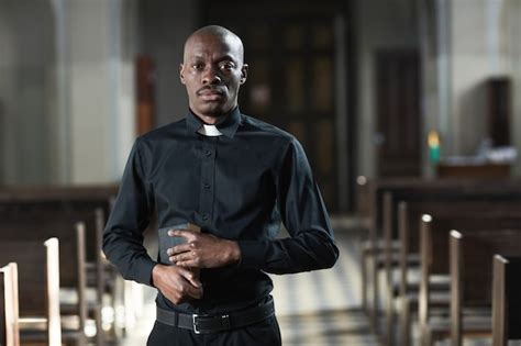 Premium Photo Portrait Of Priest Standing Isolated On Black