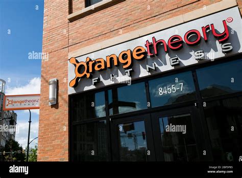 A logo sign outside of a Orangetheory Fitness location in Silver Spring