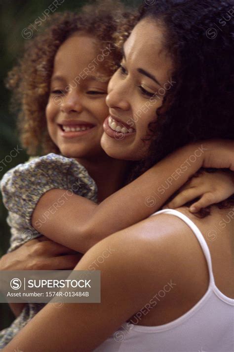 Close Up Of A Mother Hugging Her Daughter Superstock