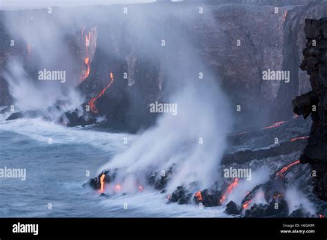 Hot Lava From Kilauea Volcano Flows Over Sea Cliffs And Through Lava