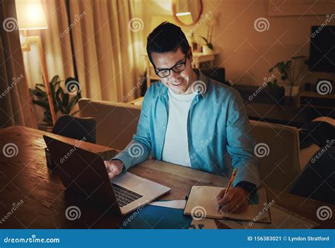 Happy Man Working Alone With An Open Laptop On A Desk At Home Stock