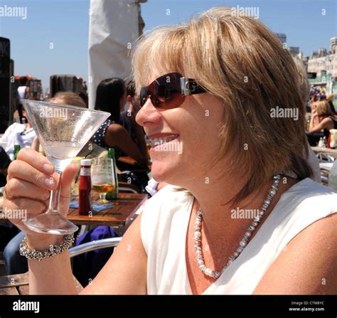 Middle Aged Attractive Blonde Female Enjoying A Margarita Cocktail Made