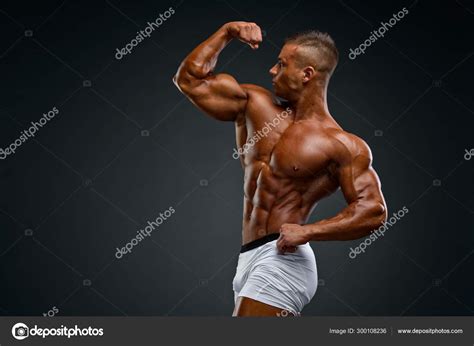 Young Handsome Muscular Men Flexing Muscles Stock Photo By ©mrbigphoto