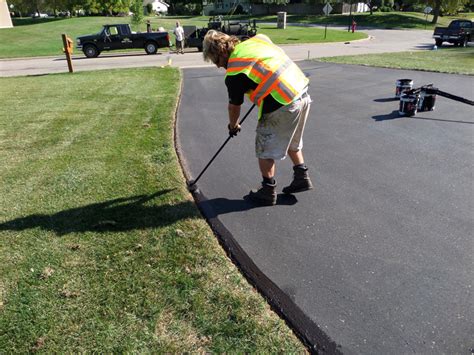 A heavy rain washed away the gravel on the edge of the driveway. Residential Asphalt Seal Coating | Minnesota Professional ...