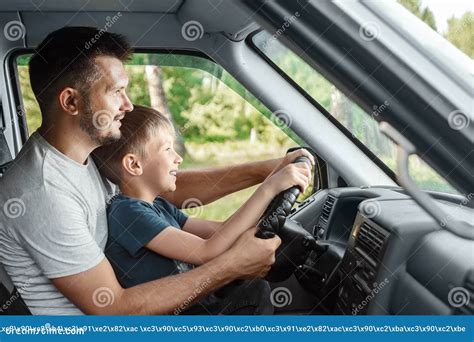 Man Father Teaches Little Son To Drive On The Road Parents And