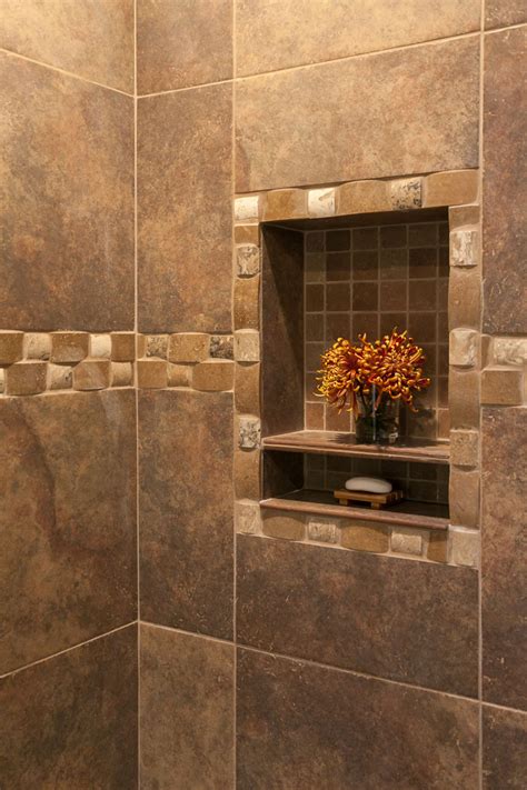 A shower dam divides the shower from the bathroom flooring to keep water contained and allows for two different flooring materials, but removing it and long, skinny tiles.as a variation on the classic subway tile, elongated rectangular tiles are an edgier and more modern take on the traditional style. Amazing Shower in this Master Bath Renovation in Denver