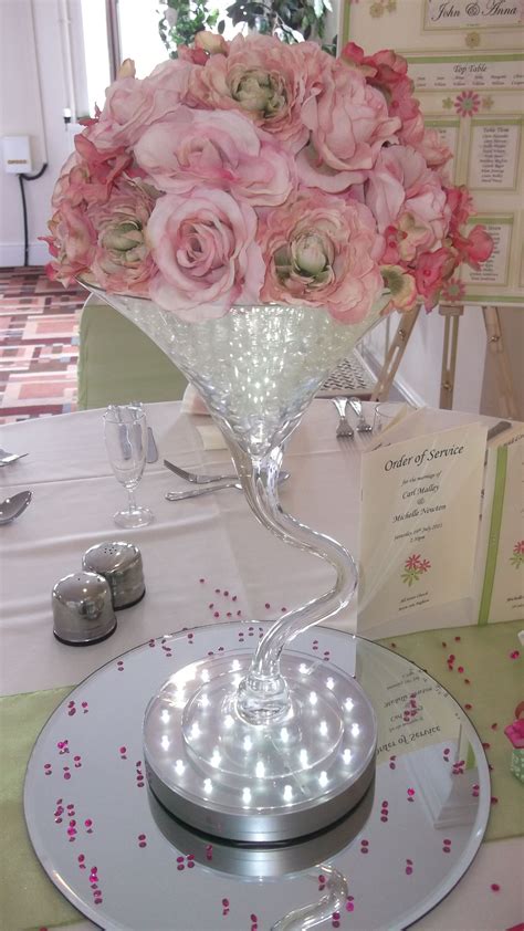 Twisted Martini Vase Weeding Centrepiece With Pink Roses Sitting On An Up Lighter And Round