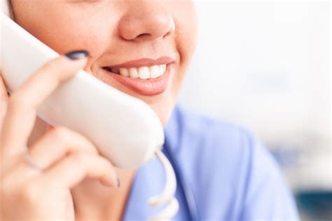 Premium Photo Woman Nurse Answering Telephone In Hospital Reception