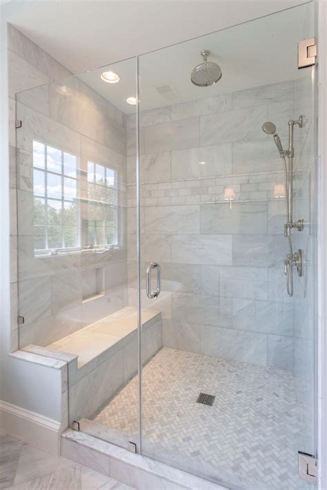 walk in glass shower with built in shower seat and marble shower walls in master bathroom of