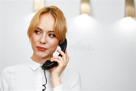 Good Looking Friendly Woman Hotel Receptionist Talking On The Phone Stock Image Image Of