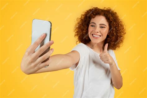 Premium Photo Smiling Teen Woman Takes Selfie Show Finger Up Sign
