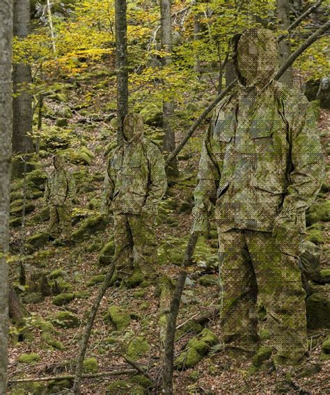 A Man In Camouflage Is Walking Through The Woods