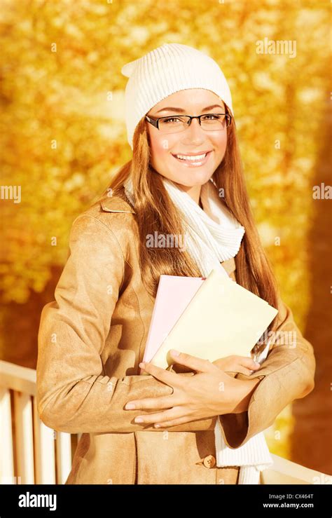 Image Of Beautiful Student Girl Holding Textbooks In Autumn Park