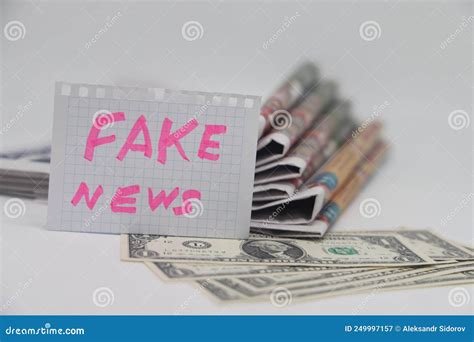 Roll Up Newspaper with a Piece of Paper that Says Fake News, Corrupt