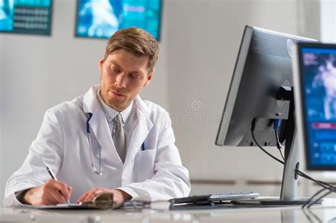 Professional Medical Doctor Working In Hospital Office Using Computer