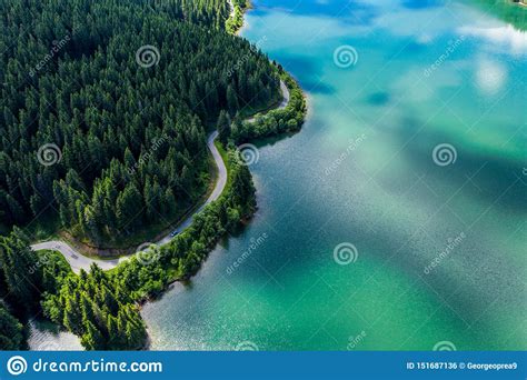 Aerial View Over Beautiful Turquoise Mountain Lake And Green Forest